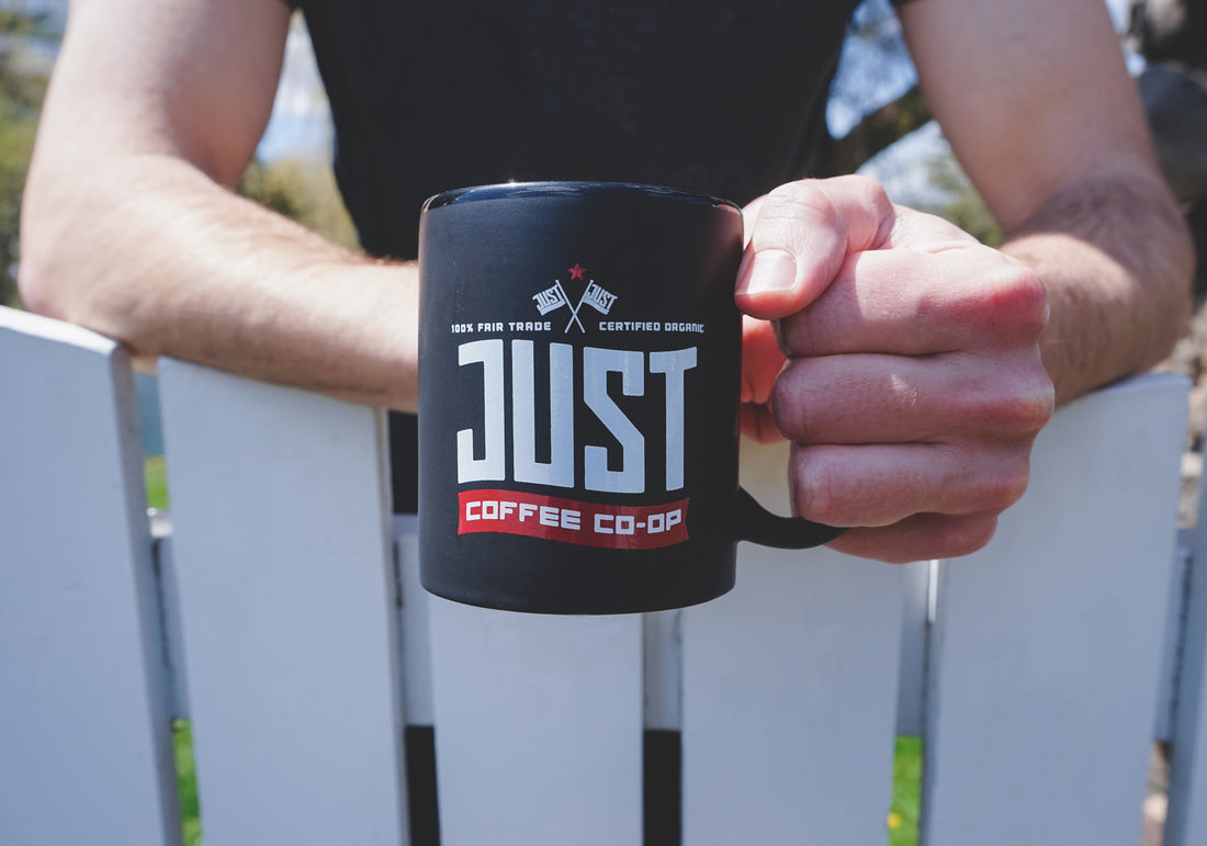 Holding mug of Just Coffee