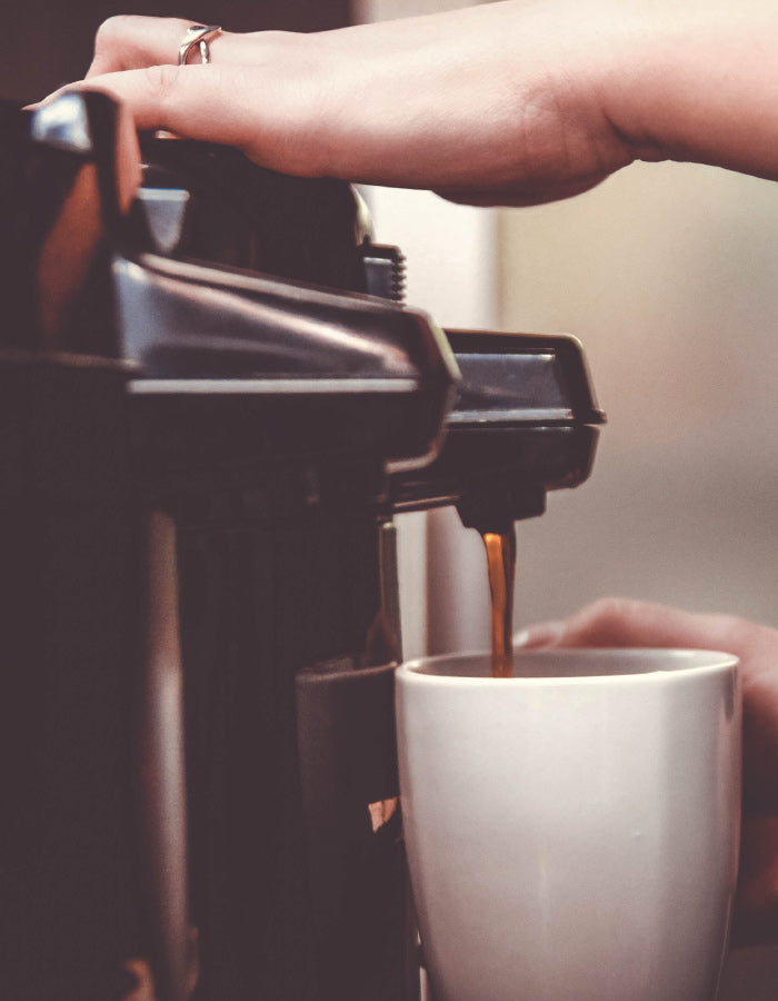 Image of coffee being poured from carafe 